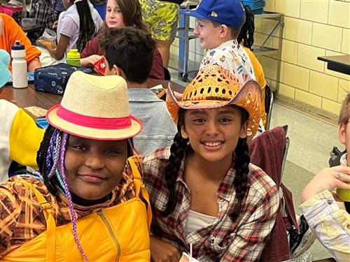 A photo of two students dressed up as a scarecrow and farmer for Halloween.