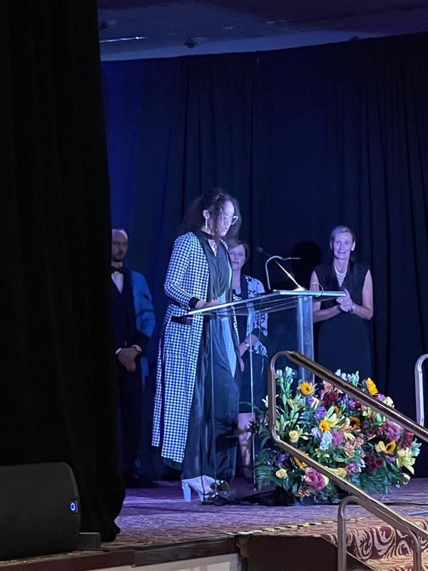  Tyla Jackson standing at podium. 
