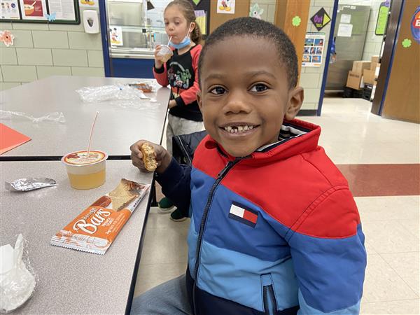 Smiling student in a school lunchroom